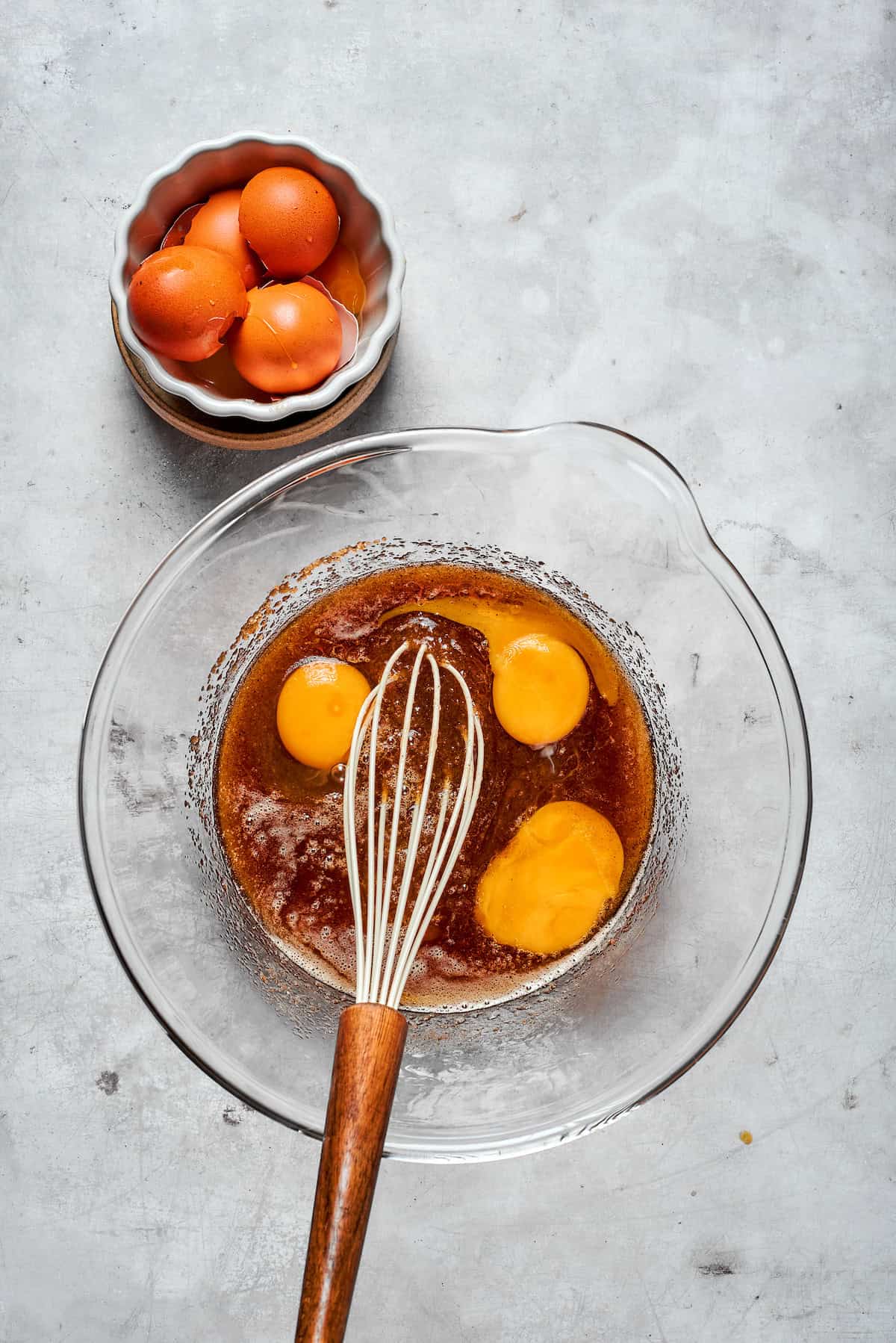 Eggs and egg yolk are added to browned butter and sugar.