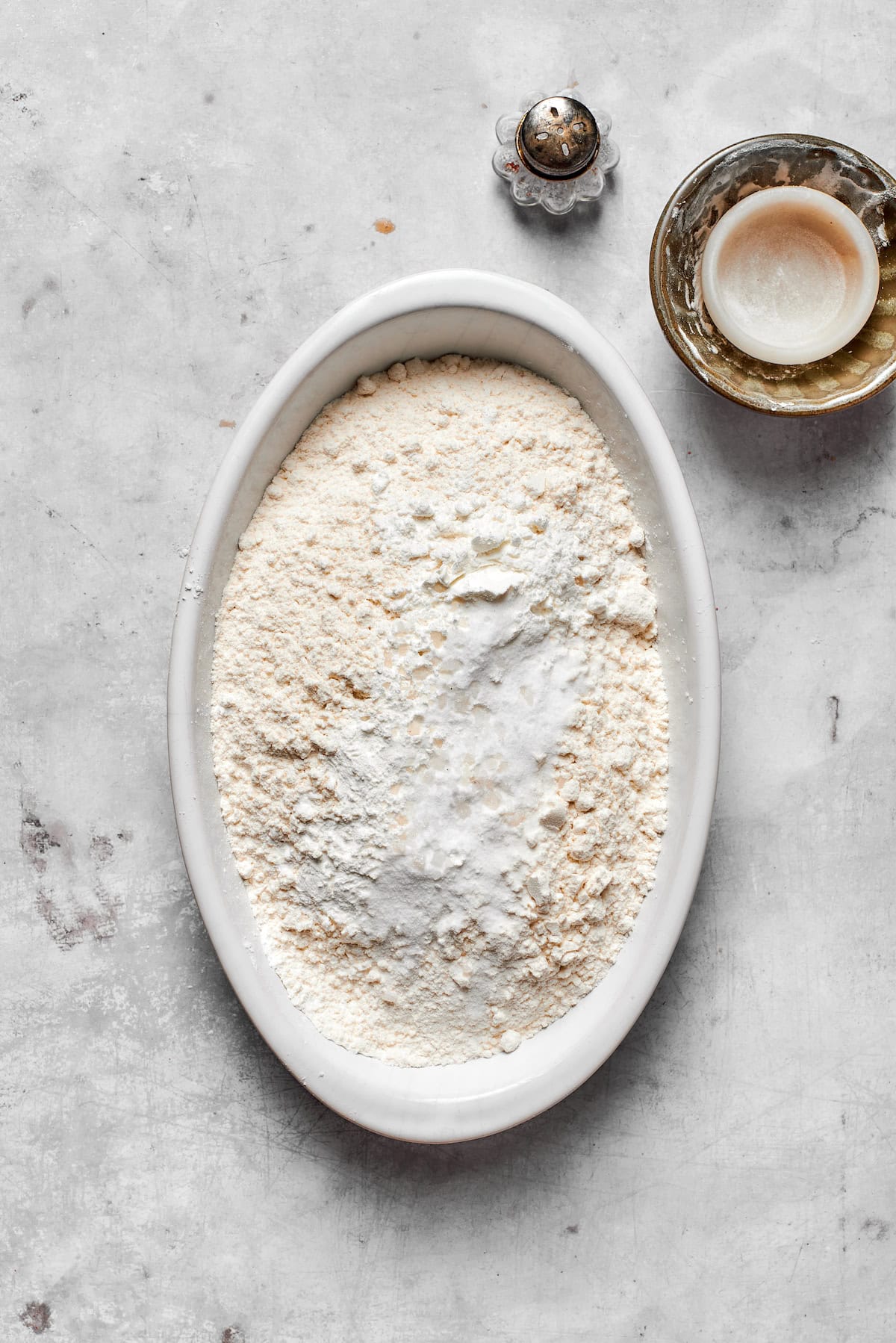 Dry ingredients for chocolate chip cookies in a dish.