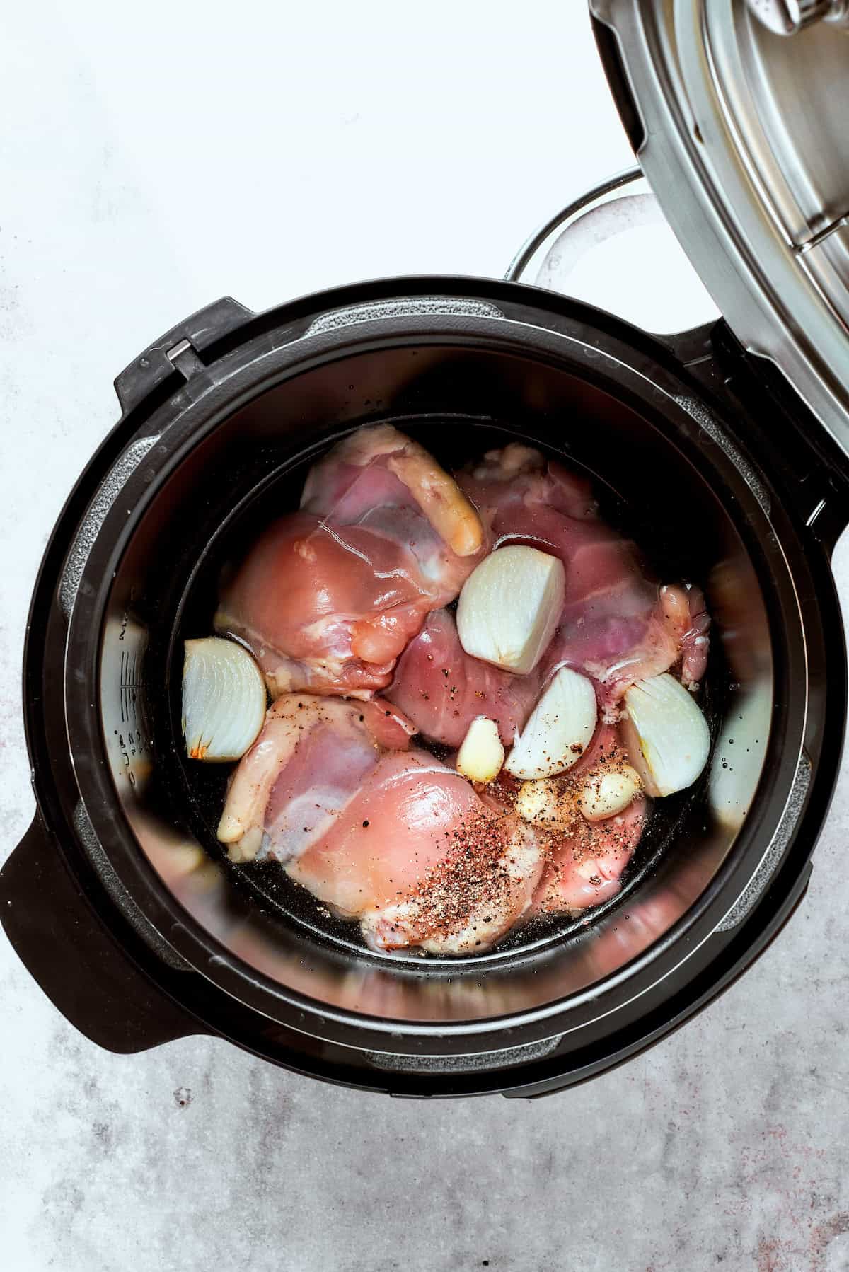 Chicken and garlic in an Instant Pot.