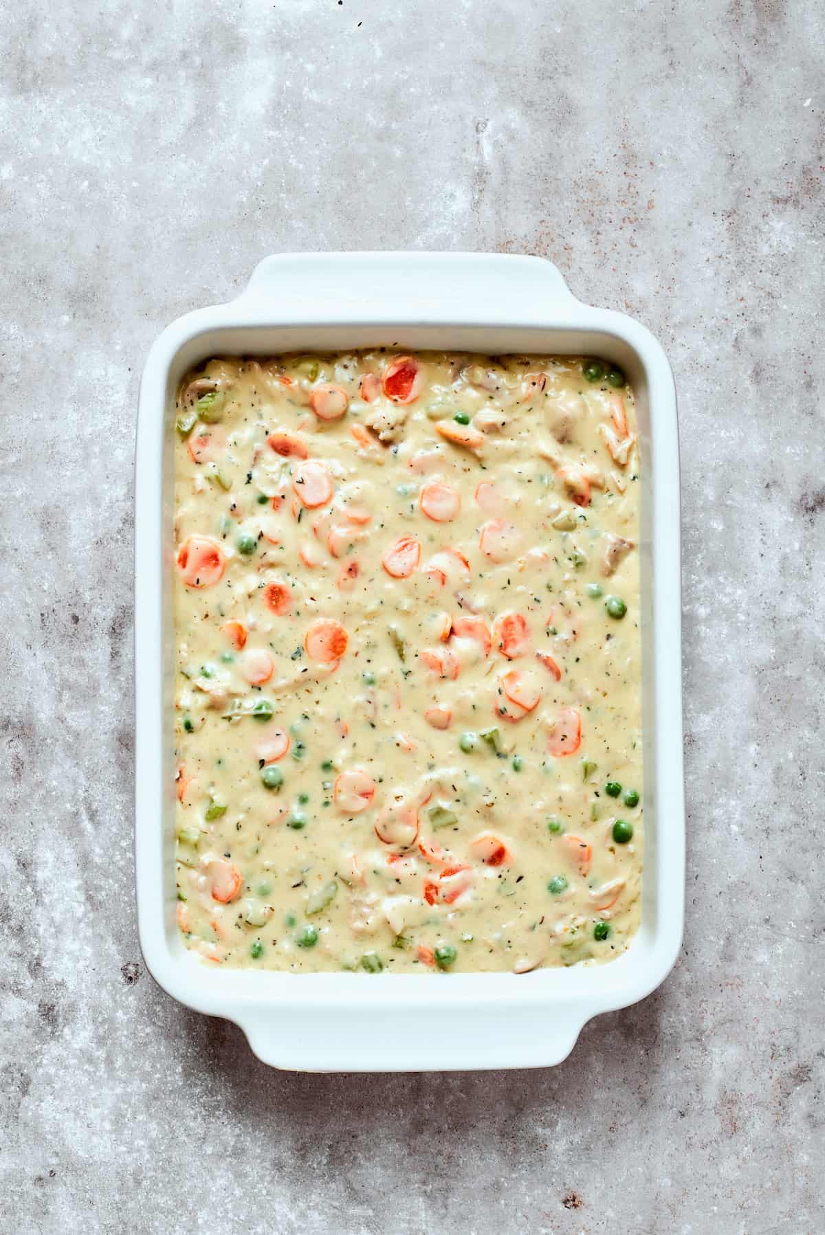 Chicken pot pie filling in a baking dish.