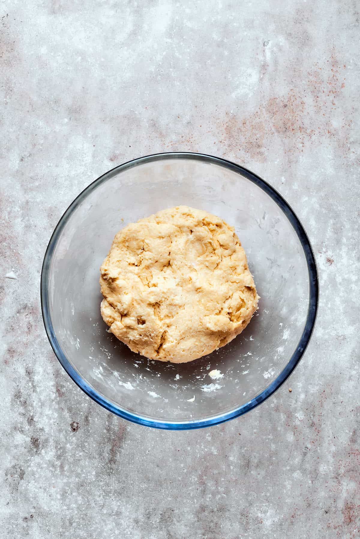 Dough for biscuits in a glass bowl.