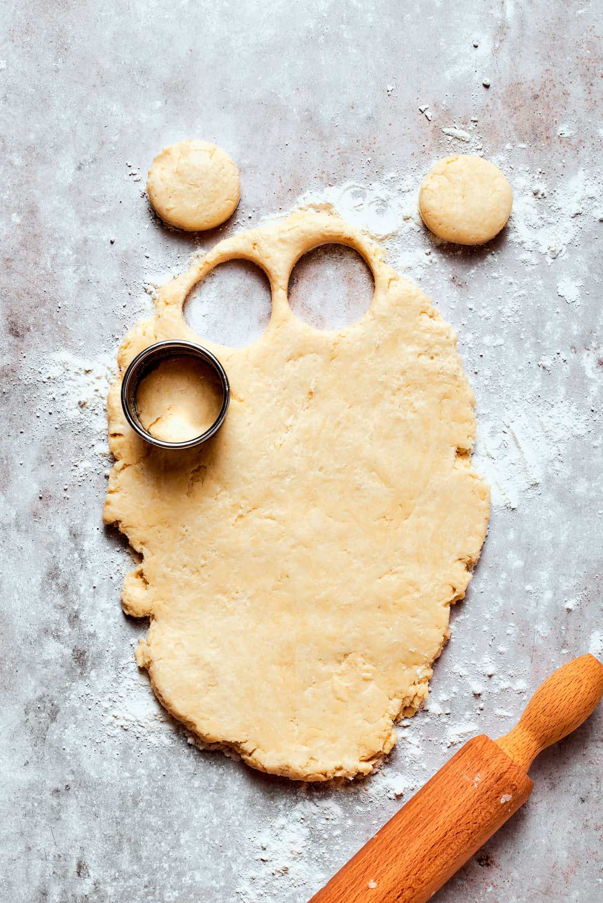 Cutting biscuits out of rolled out dough.