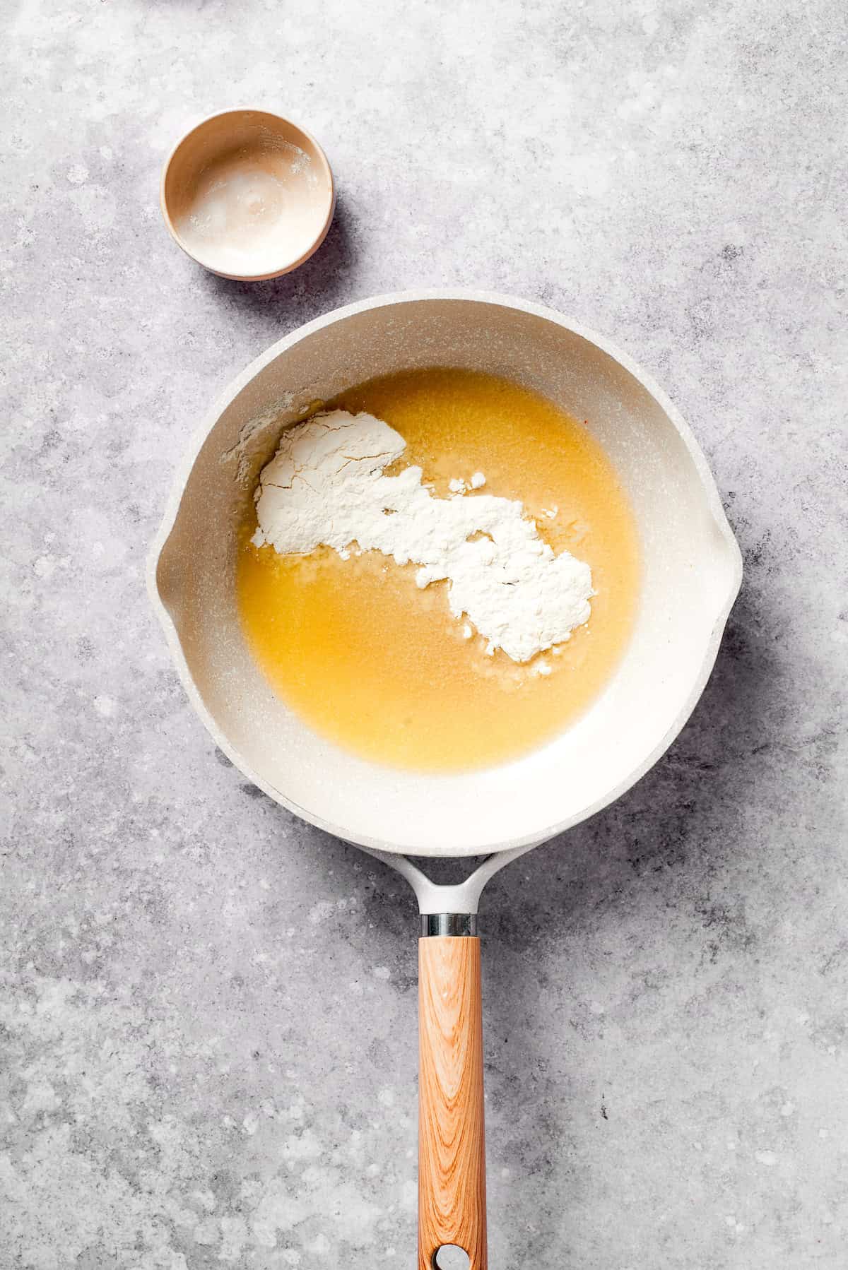 Flour is added to a skillet of melted butter.