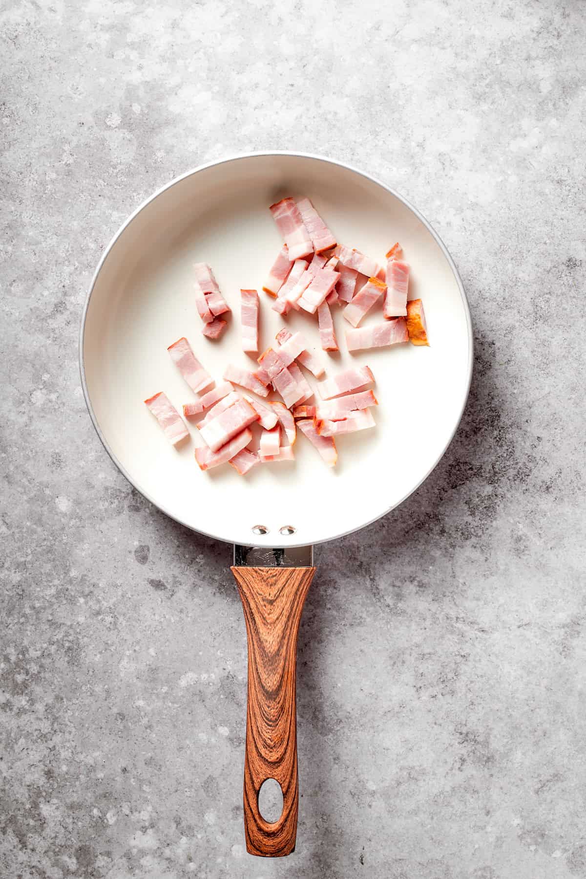 Chopped bacon in a pan.