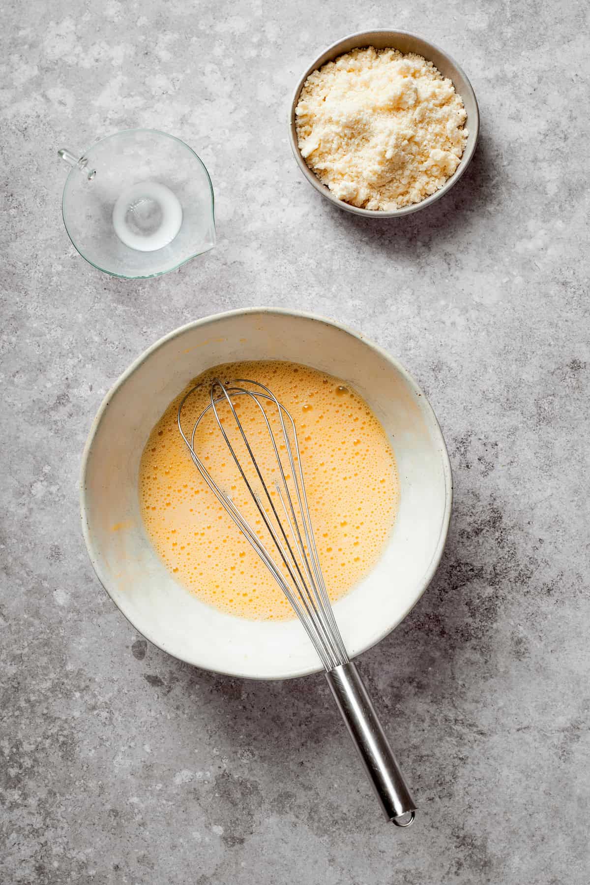 Milk and egg whisked in a bowl.