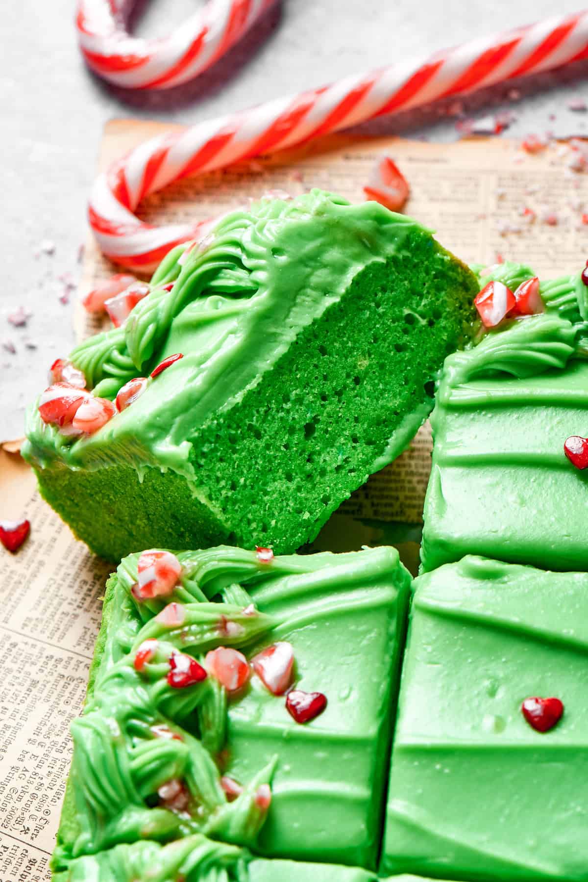 A slice of green cake turned on its side.