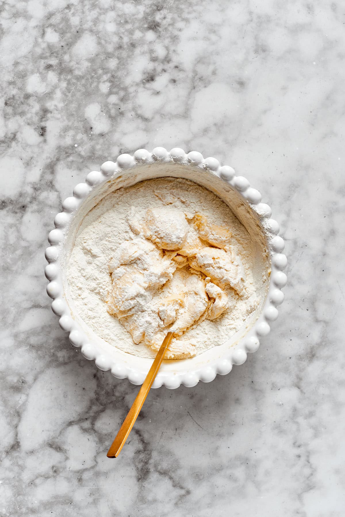 Flour is mixed into cookie dough.