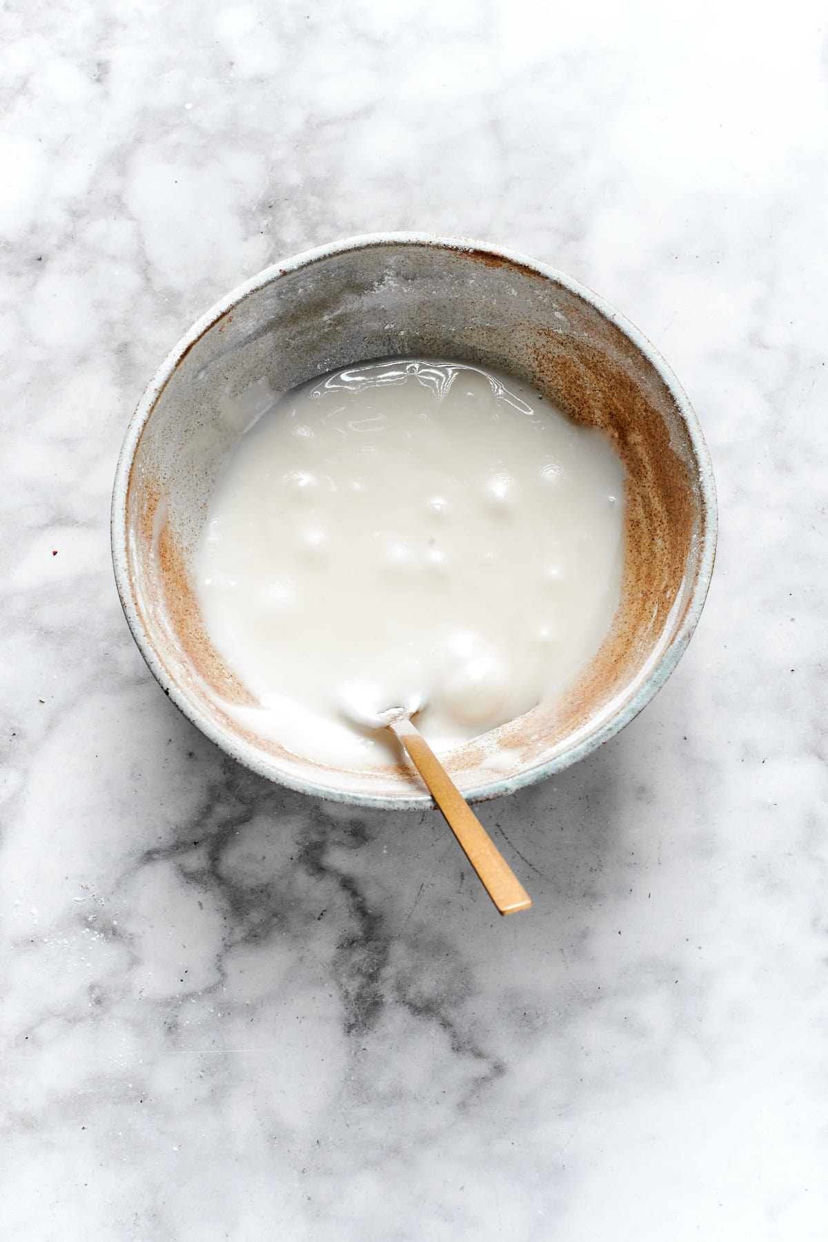 White icing mixed in a bowl.