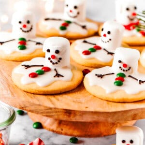 Melting snowman cookies are arranged on a cake plate.