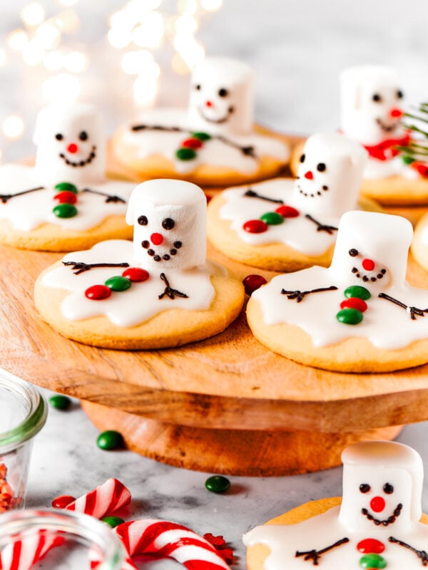 Melting snowman cookies are arranged on a cake plate.