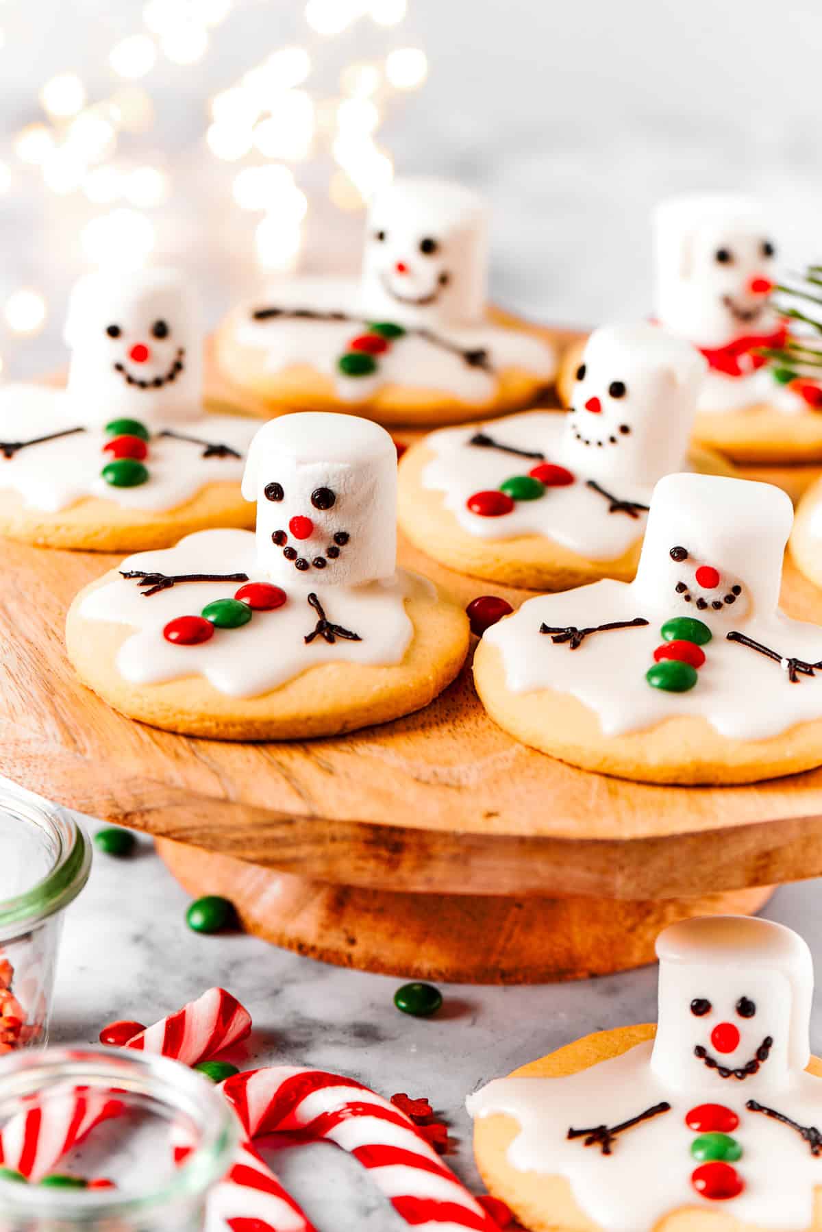 Melting snowman cookies are arranged on a cake plate.