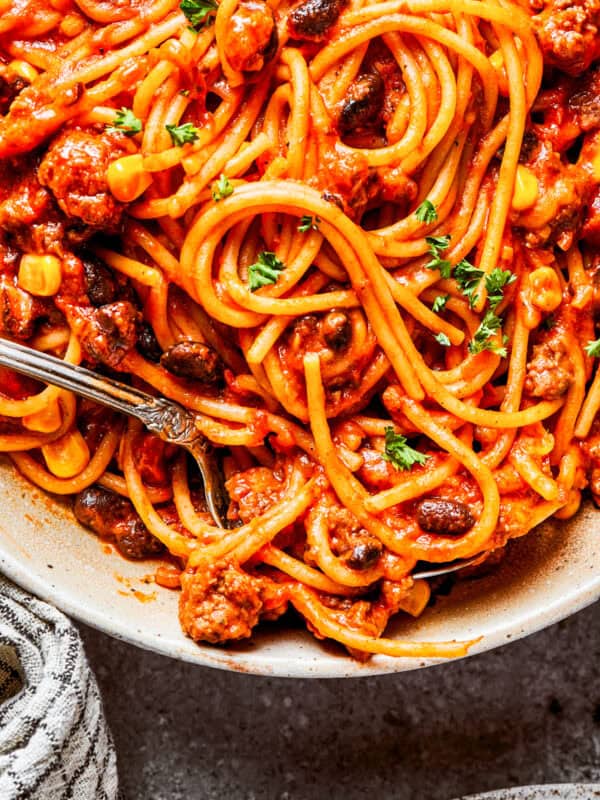 Close-up image of cooked spaghetti in sauce.