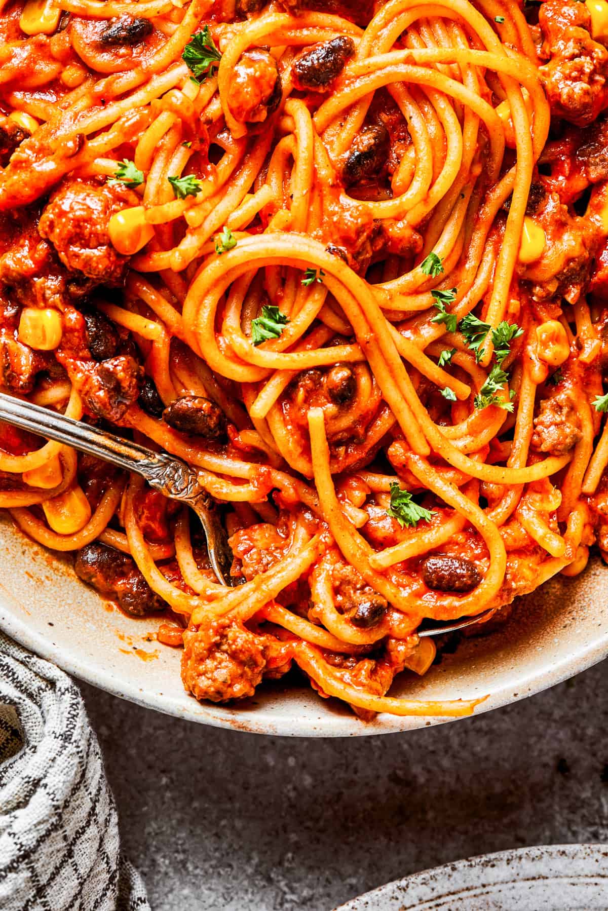 Close-up image of cooked spaghetti in sauce.