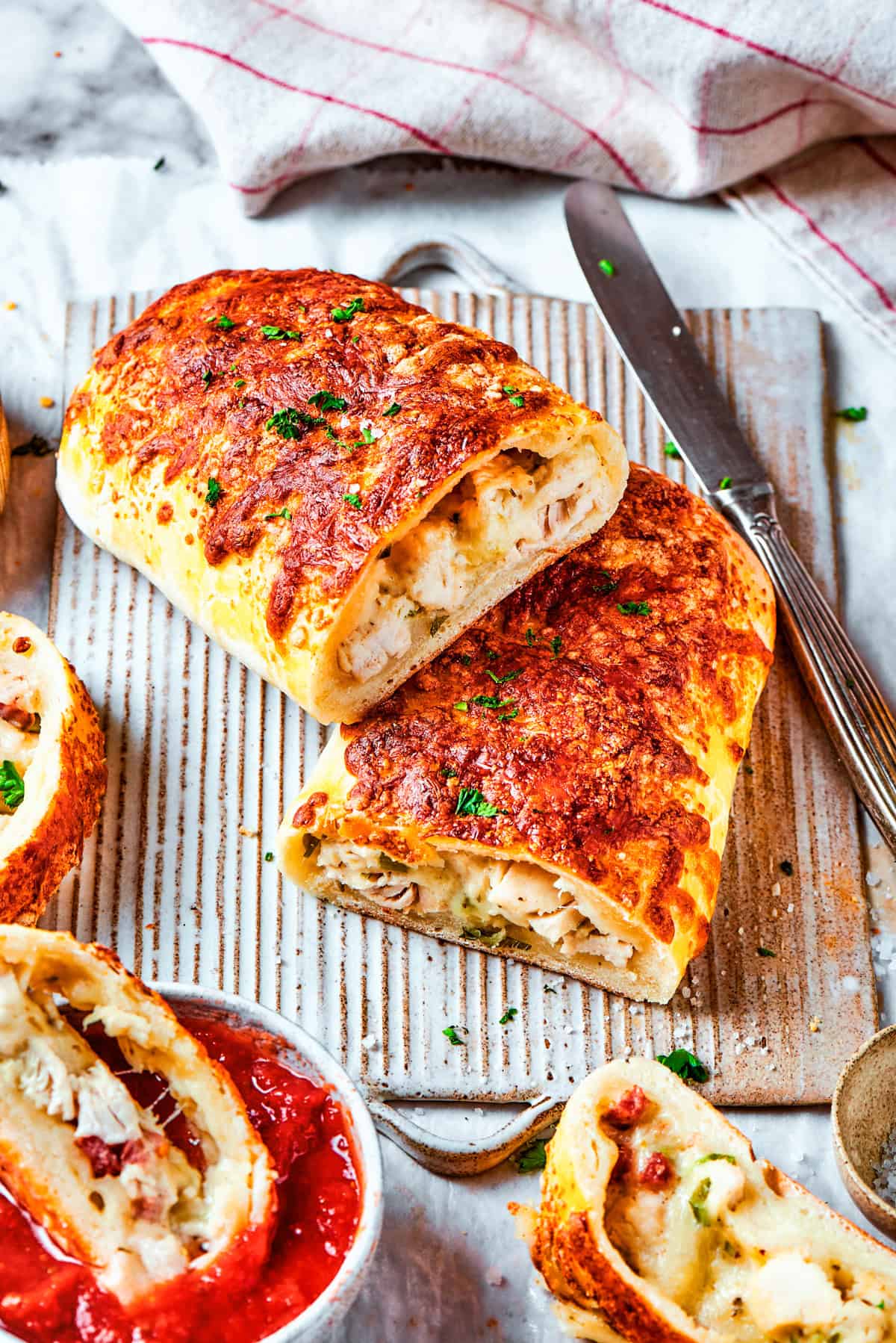 Halved chicken bake sandwiches stacked one on top of the other.