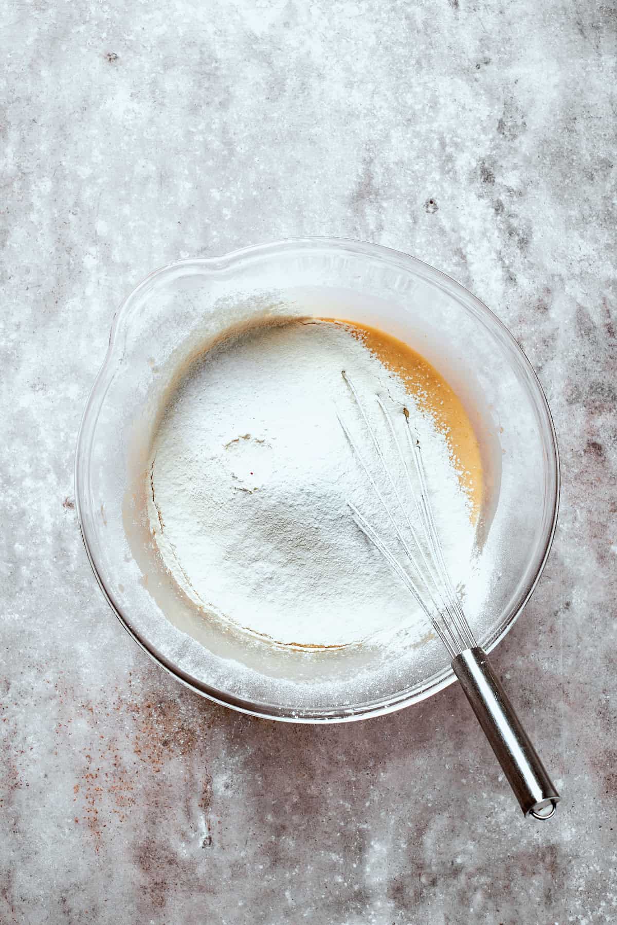 Flour is mixed into banana bread batter.