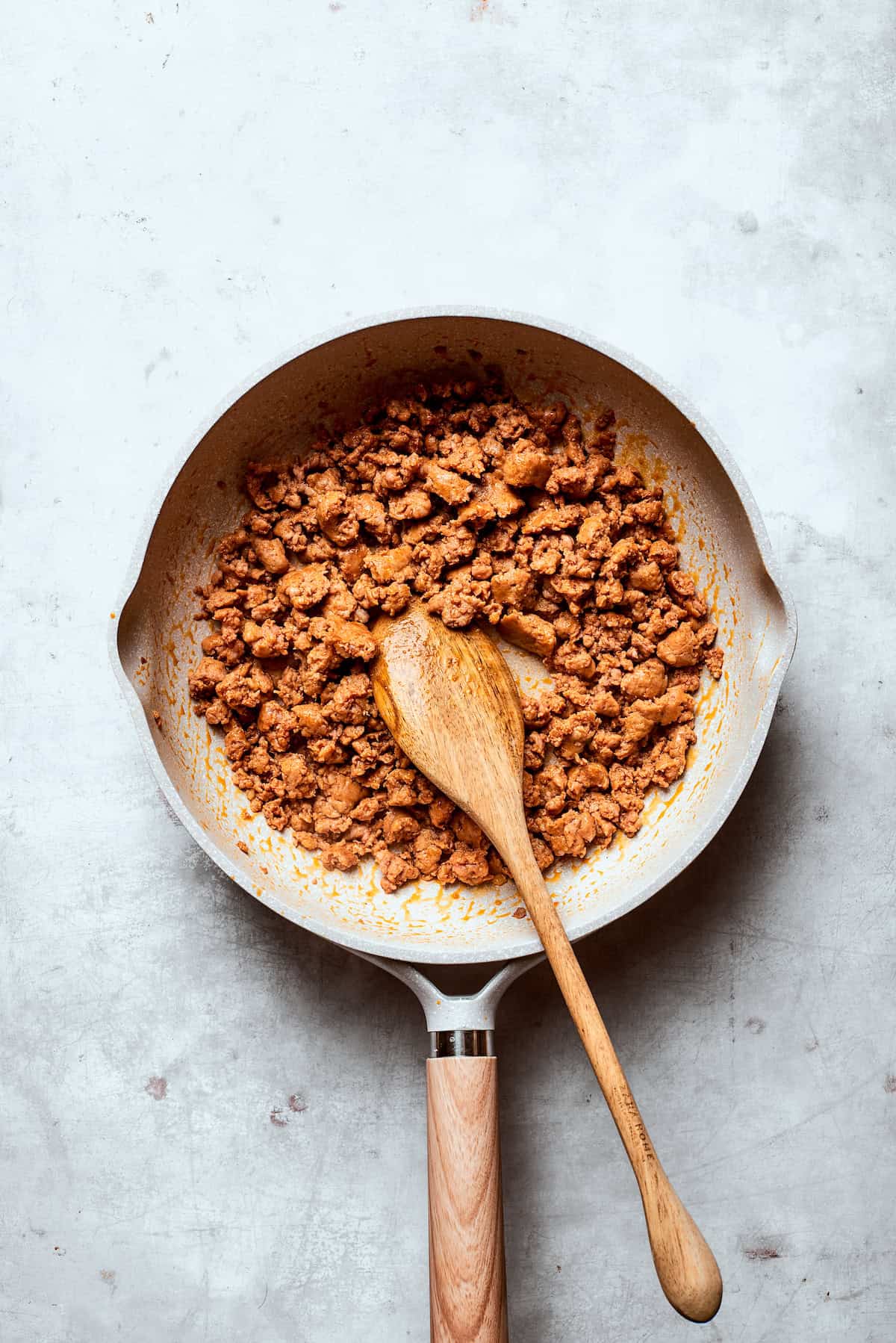 Sausage browns in a skillet.