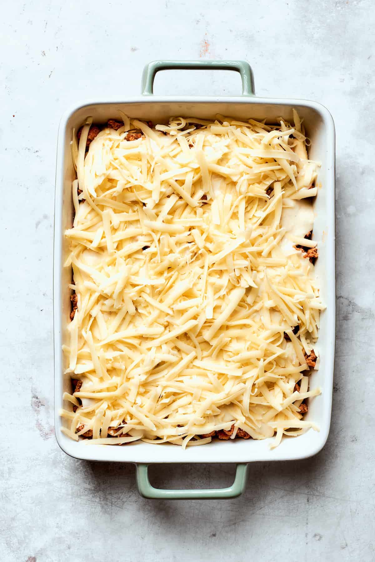 Cheese is added to biscuits and gravy casserole.