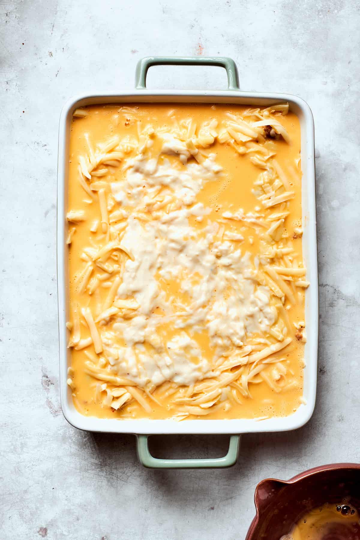 Eggs are poured into a pan of biscuits and gravy casserole.