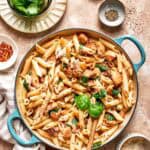 A skillet of marry me chicken pasta on a table.