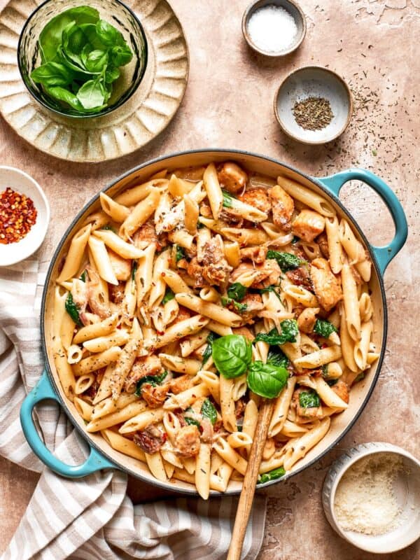 A skillet of marry me chicken pasta on a table.