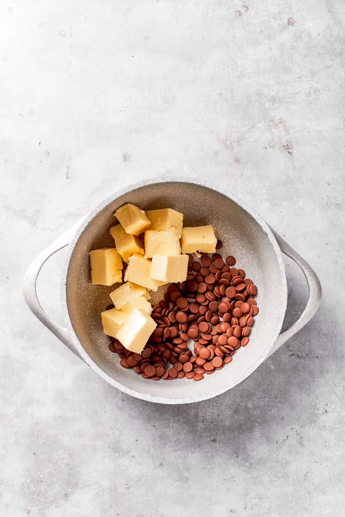 Cubes of butter are added to a pot.