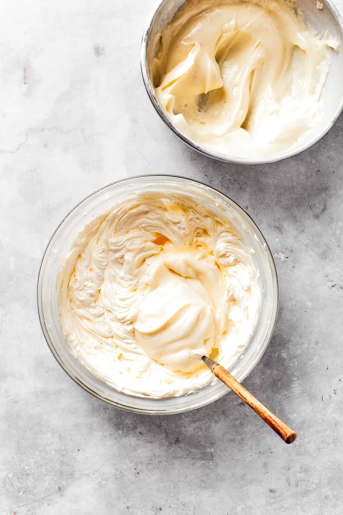 Cream cheese frosting is mixed in a bowl.