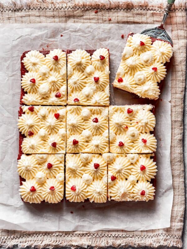 A spatula removes a red velvet brownie.