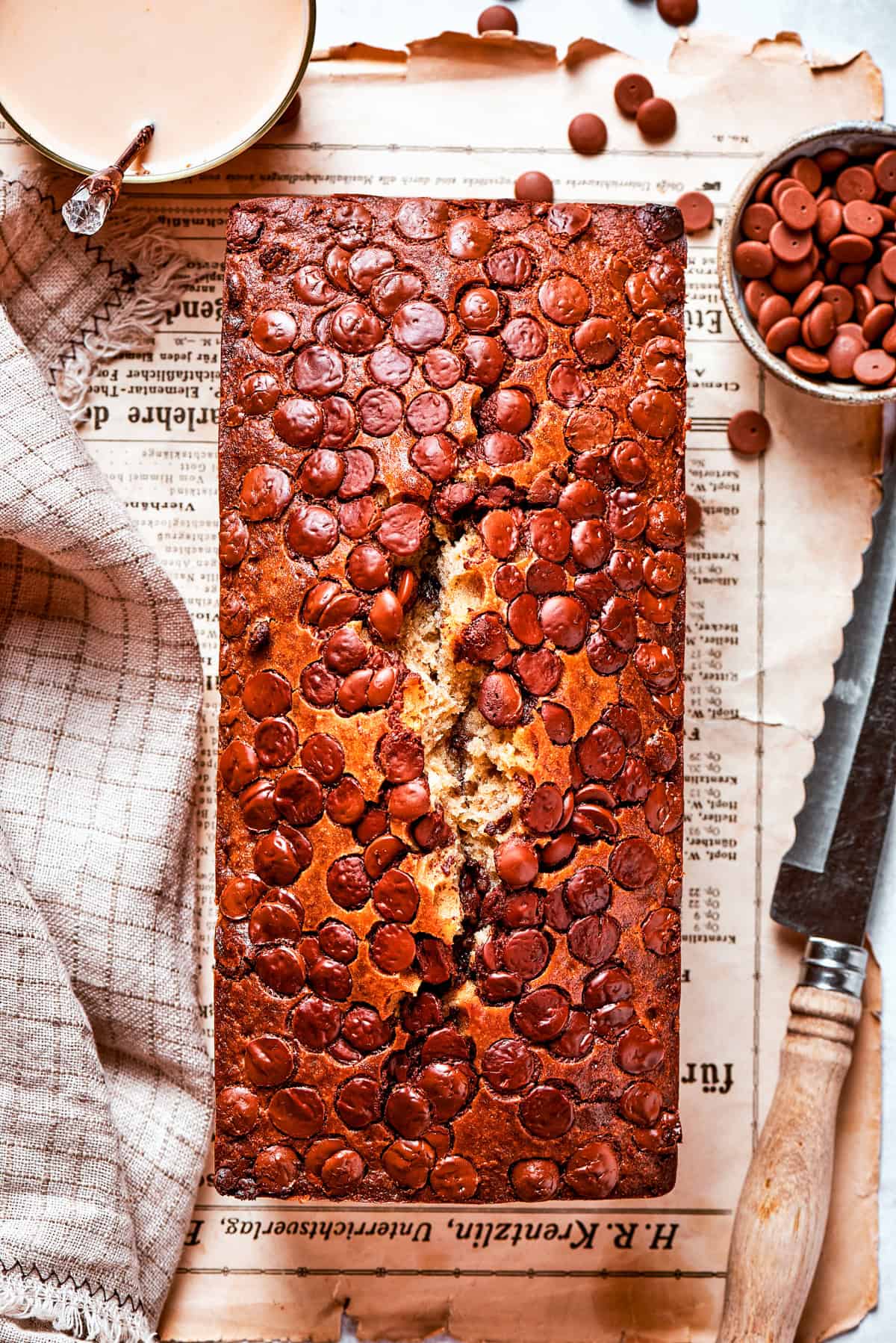 Overhead shot of chocolate chip banana bread set on a table.