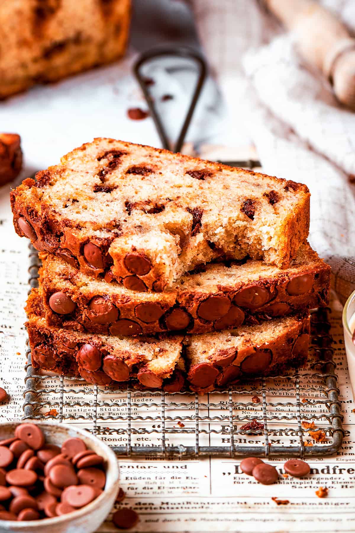 Three slices of banana chocolate chip bread stacked on top of each other.