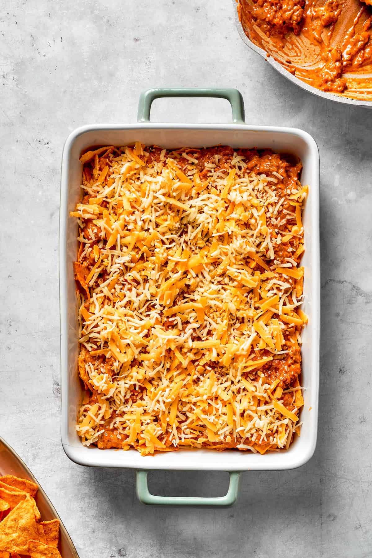 An assembled Dorito casserole in a casserole dish.