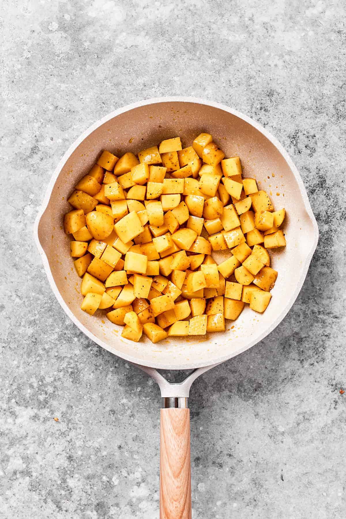 Cubes of potatoes browning in a skiillet.