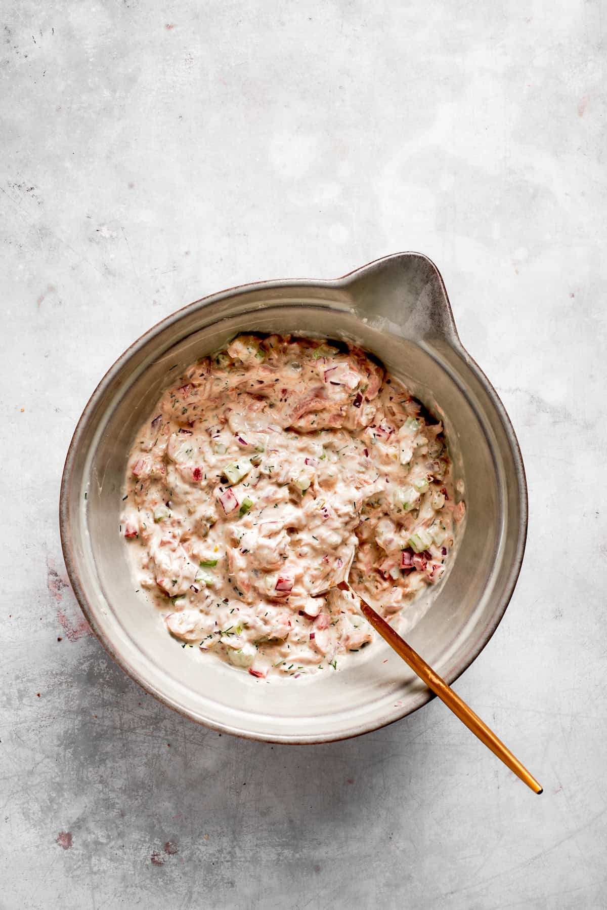 Ingredients for tuna melt filling are mixed together in a bowl.