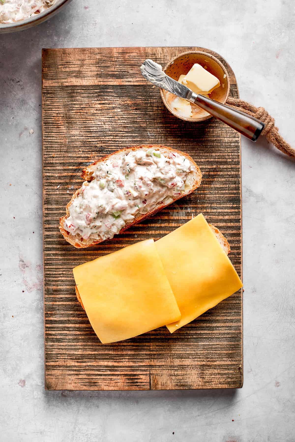 Two slices of cheese placed on a slice of bread.