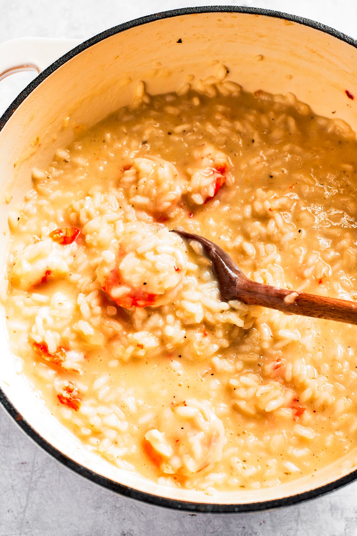 Stirring through rice in a pot.