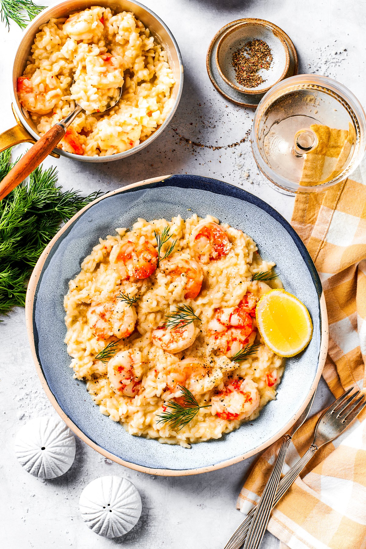 A serving of risotto with shrimp on a dinner plate.