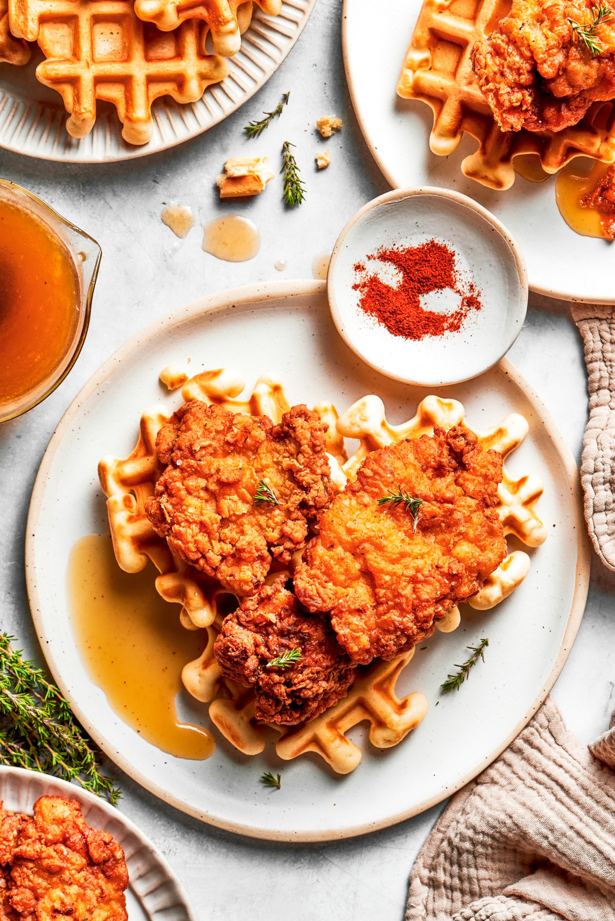 Fried chicken on top of waffles with melted honey butter.