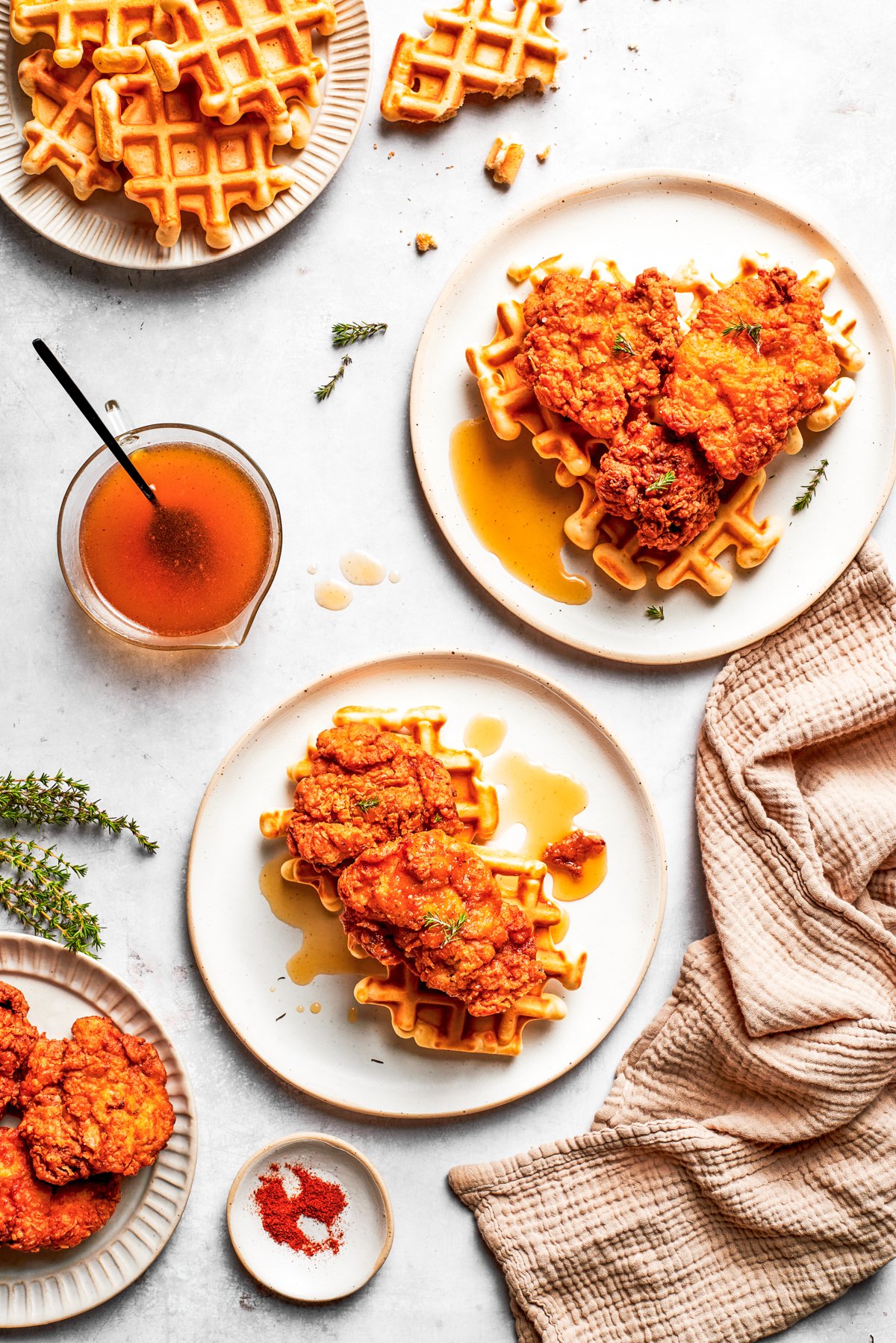 Chicken and waffles served on dinner plates.