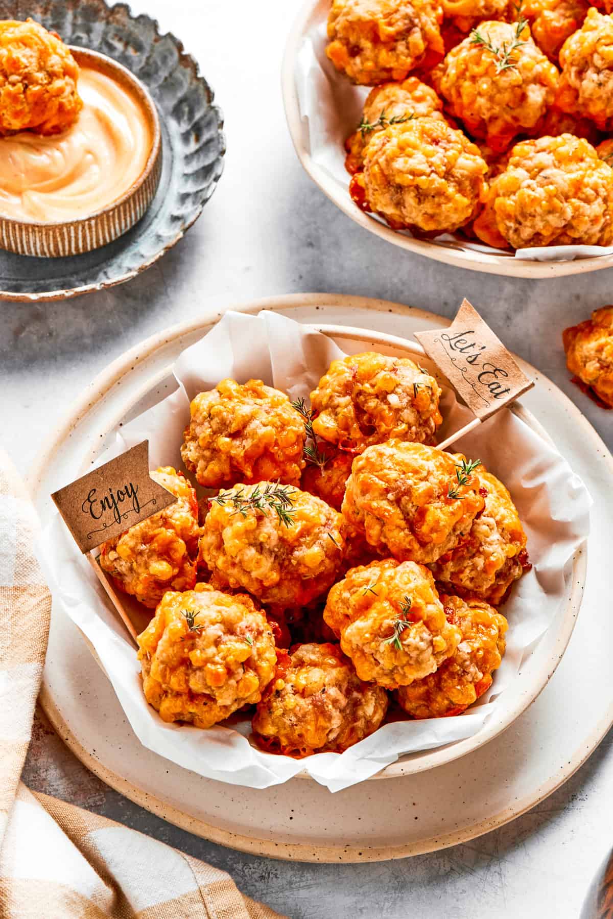 Two bowls filled with baked sausage balls.