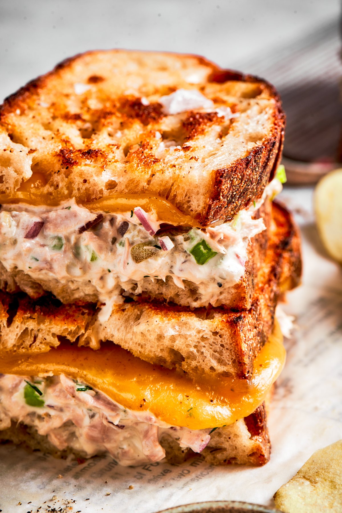 Close up shot of two tuna melt sandwiches stacked up.