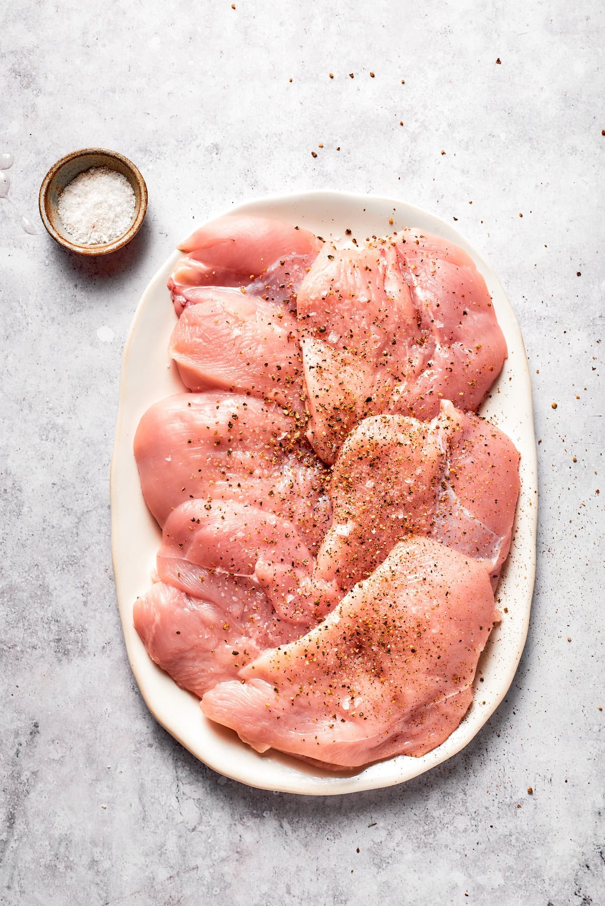 Chicken breasts after being pounded and seasoned.