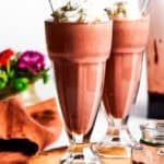 Chocolate milkshakes topped with whipped cream.