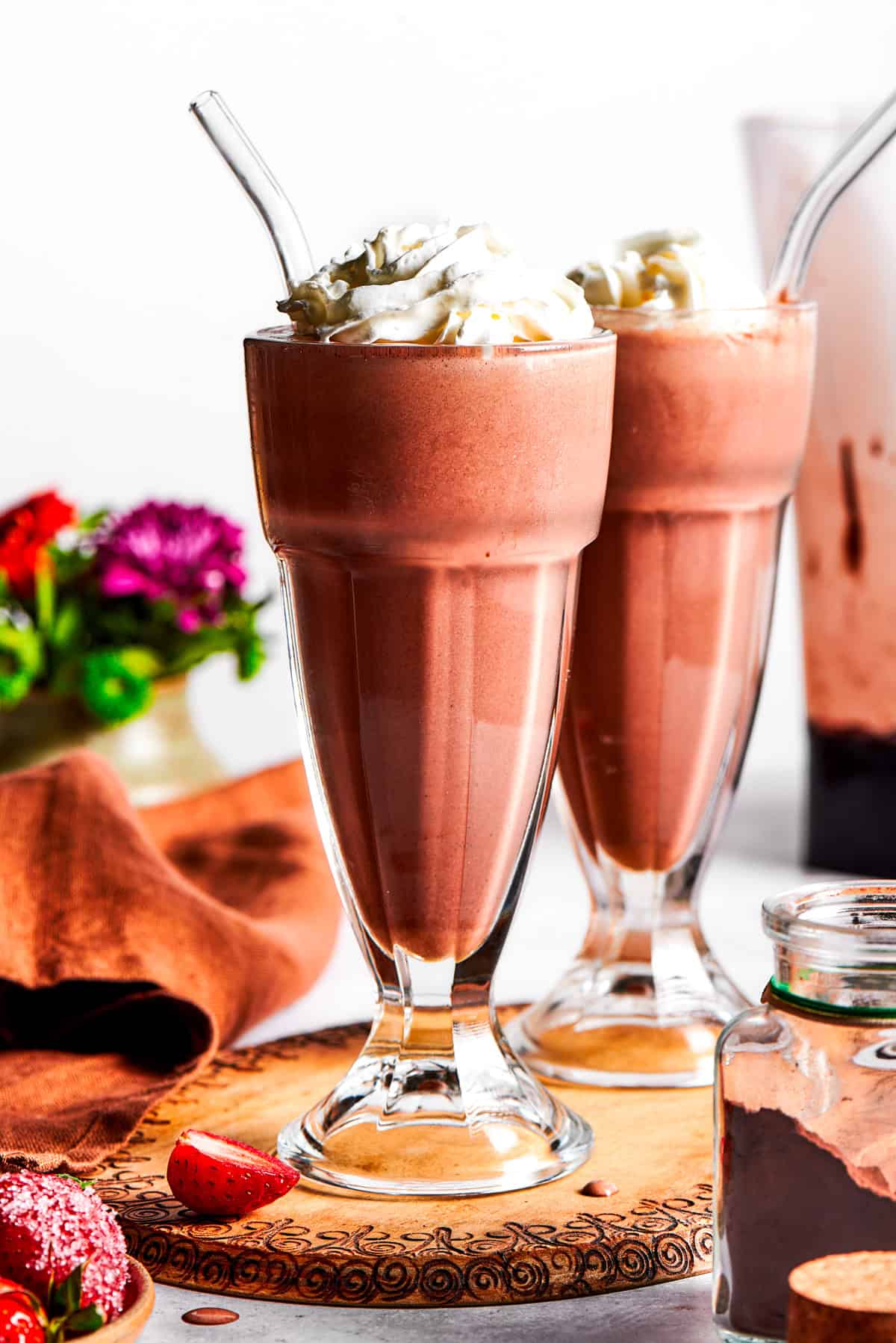 Chocolate milkshakes topped with whipped cream.