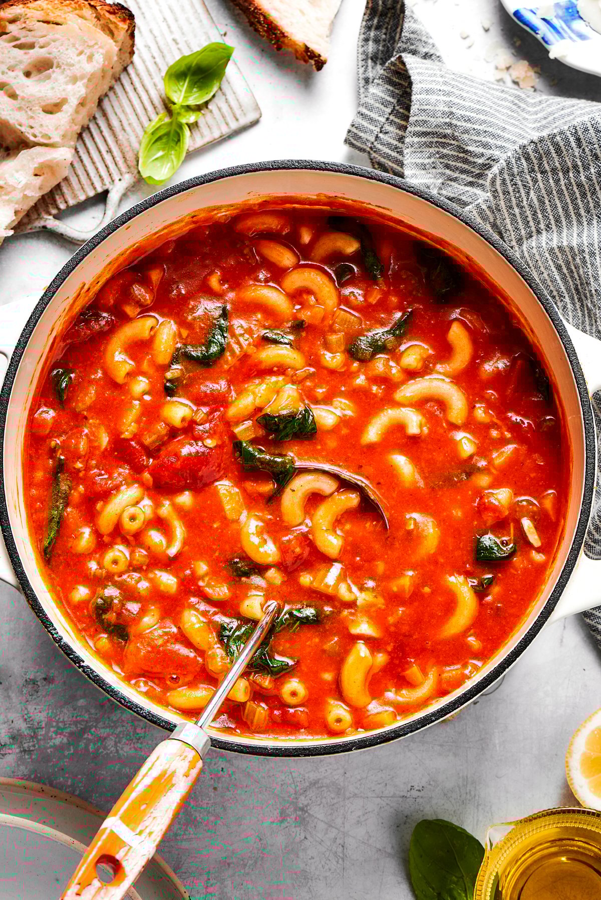 Tomato Florentine soup is deliciously hearty, packed with vegetables, herbs, spinach, and pasta simmered in a tomato-based broth. A pot of tomato Florentine soup.