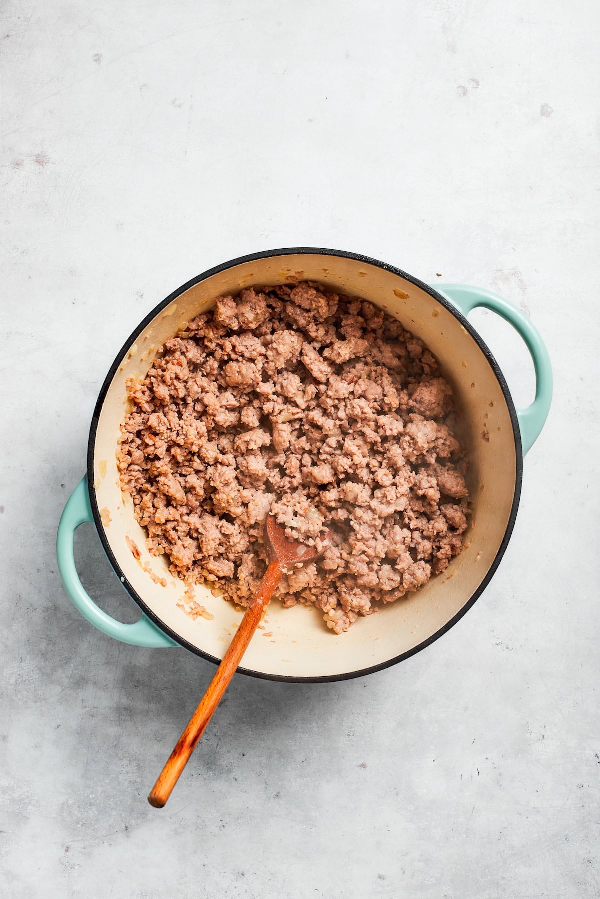 Beef cooks down in a skillet.