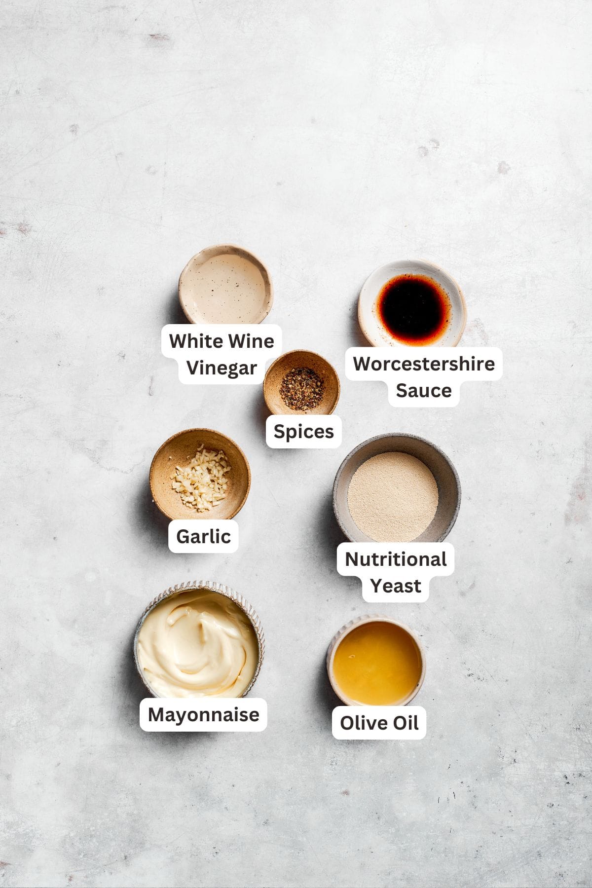 Ingredients for caesar dressing are portioned and labeled.