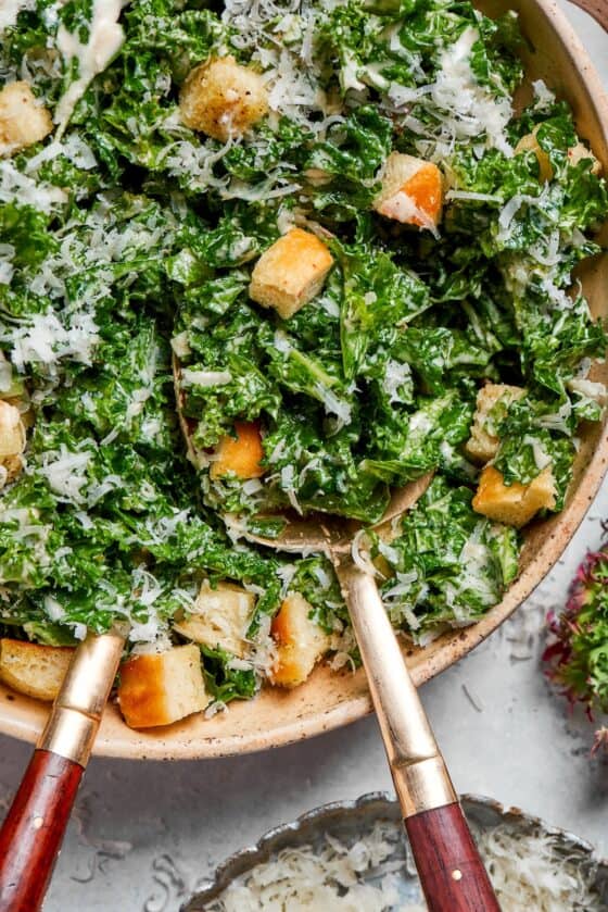 Homemade croutons top a bowl of kale salad.