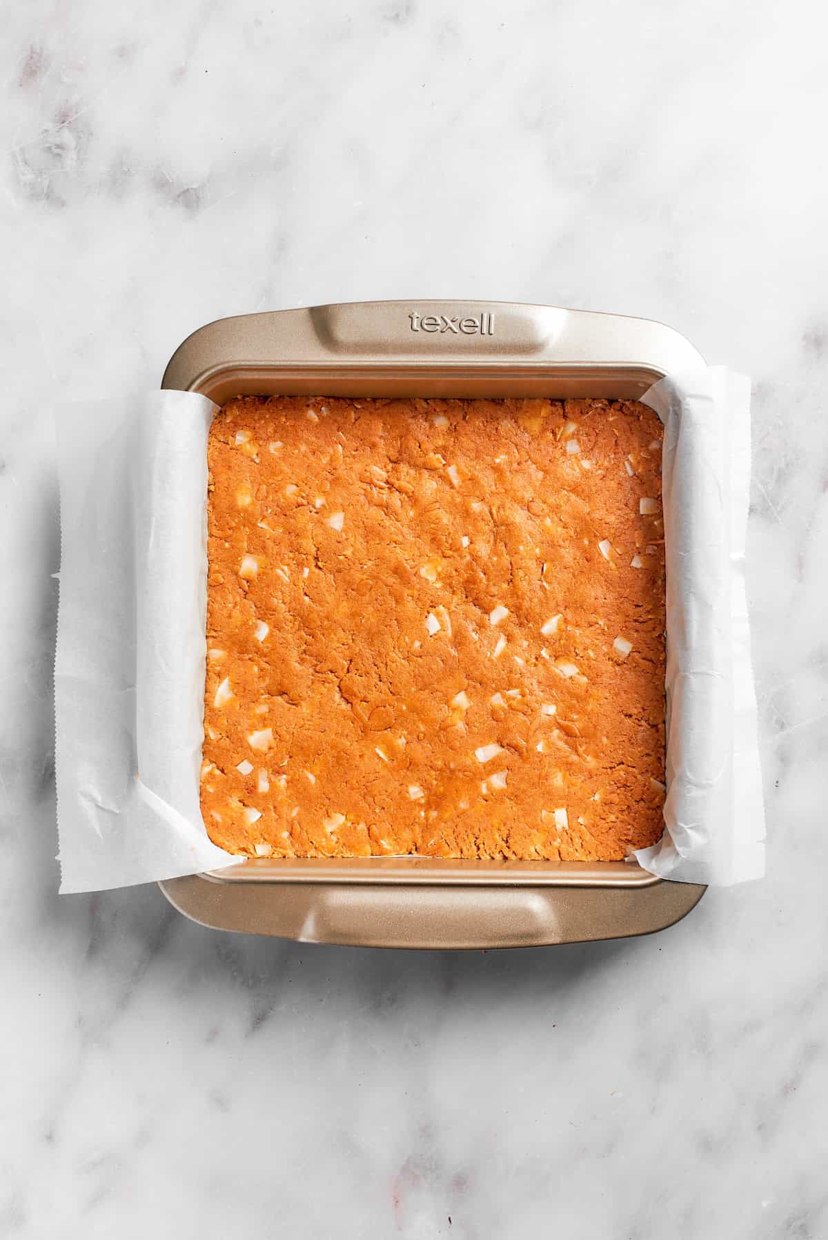 Graham cracker crust is pressed in a pan.