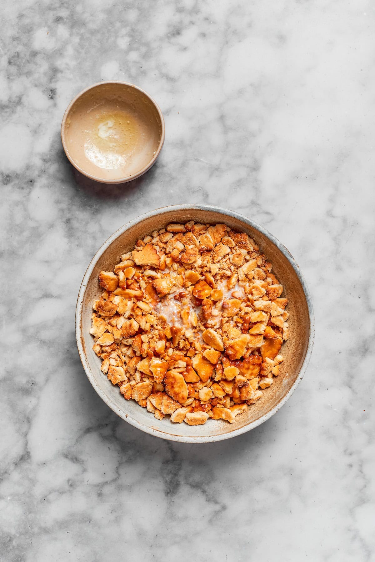 Crumbled ritz crackers in a bowl.