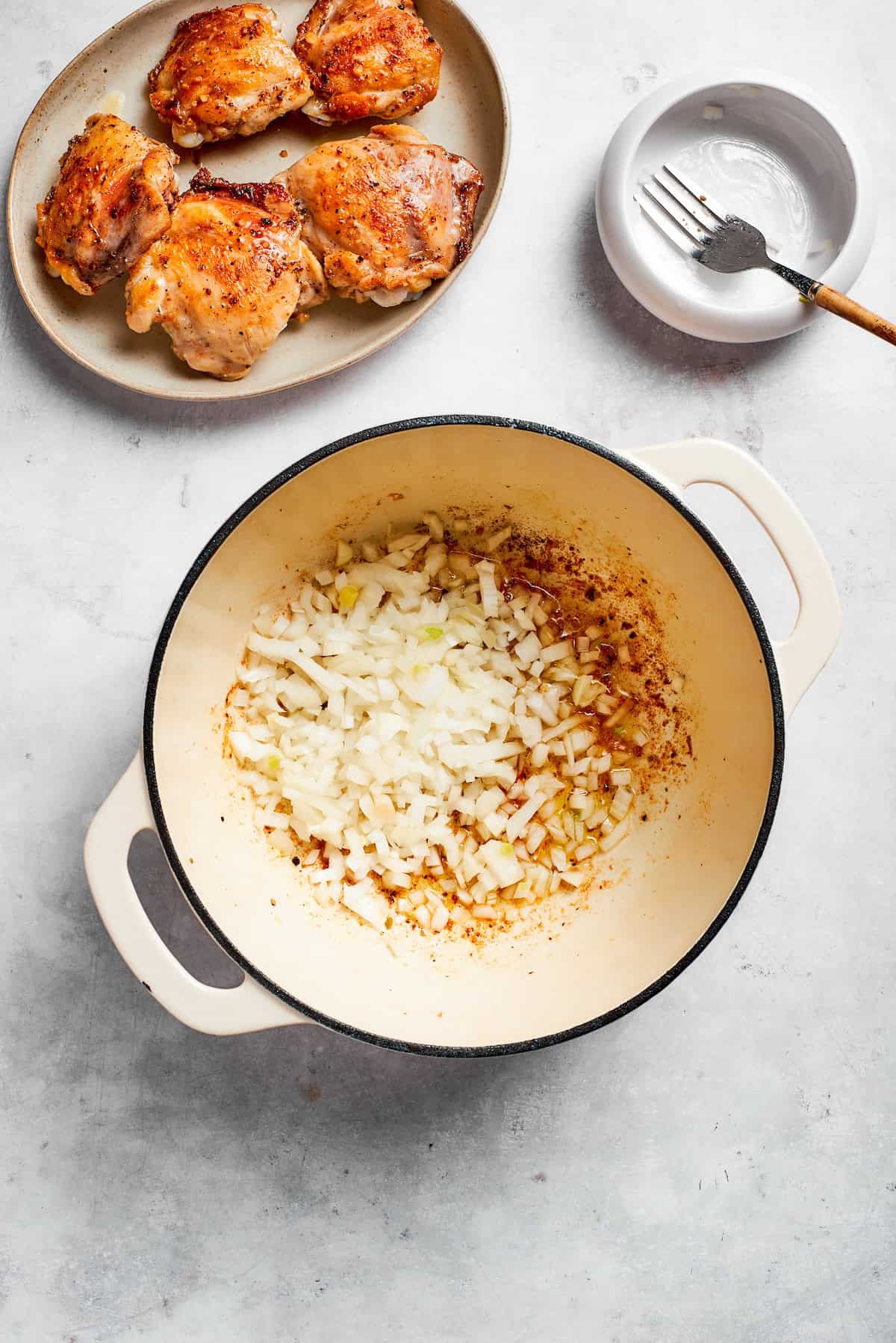 Garlic and onion are added to a pot.