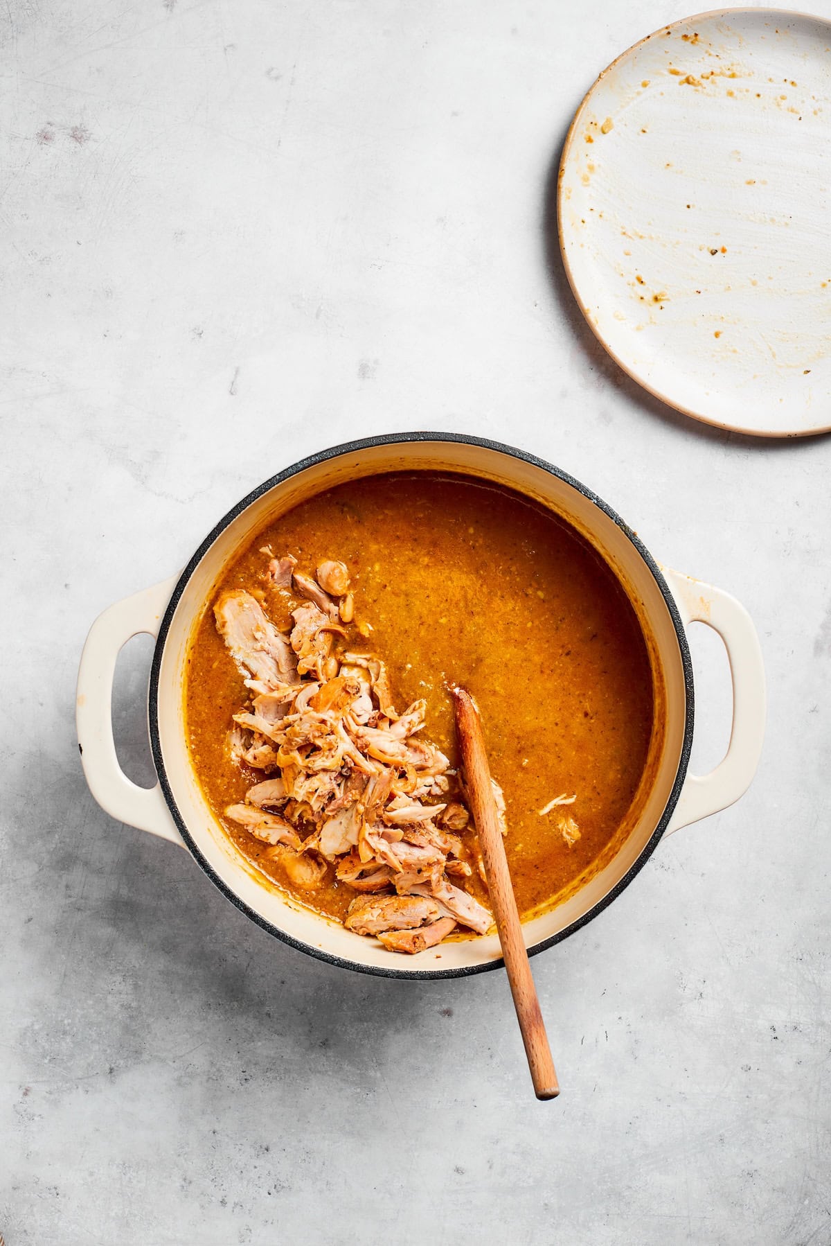 Chicken is added back into a soup pot.